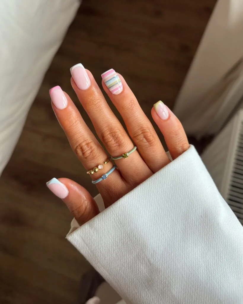 June nail ideas, baby pink short square nails with pastel French tips and candy stripe accent nail
