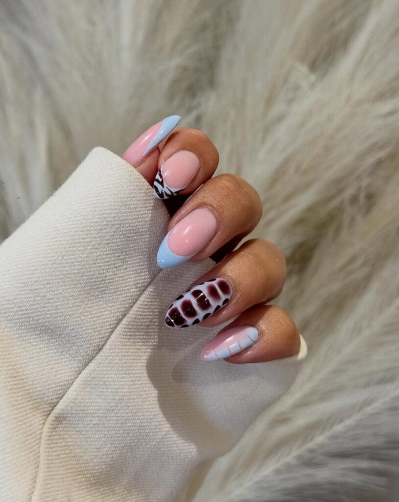 June nail ideas, baby blue French tip almond nails with burgundy croc and cow print accent nails
