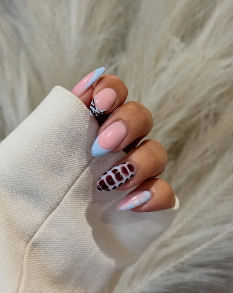 June nail ideas, baby blue French tip almond nails with burgundy croc and cow print accent nails

