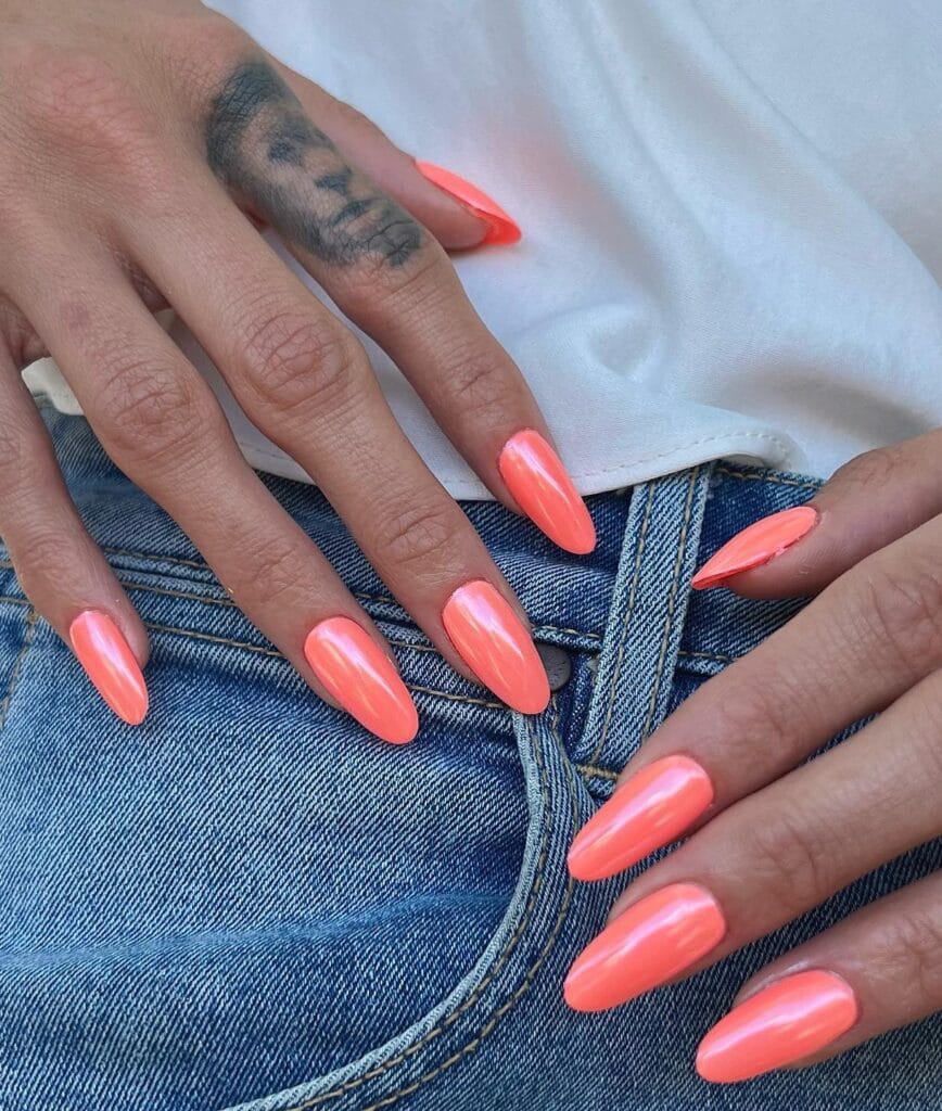 summer nail colors, coral glossy almond nails with denim and white tee