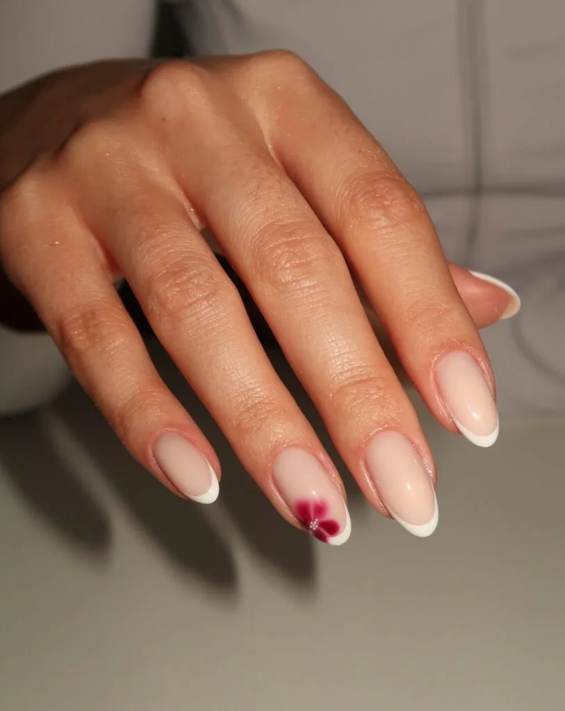 summer nail trends 2026, French tip almond nails with single red flower accent