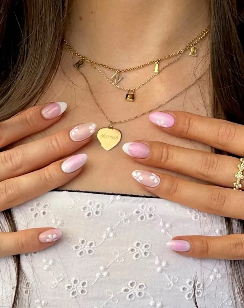 ummer nail trends 2026, pink ombre almond nails with small white flower accents