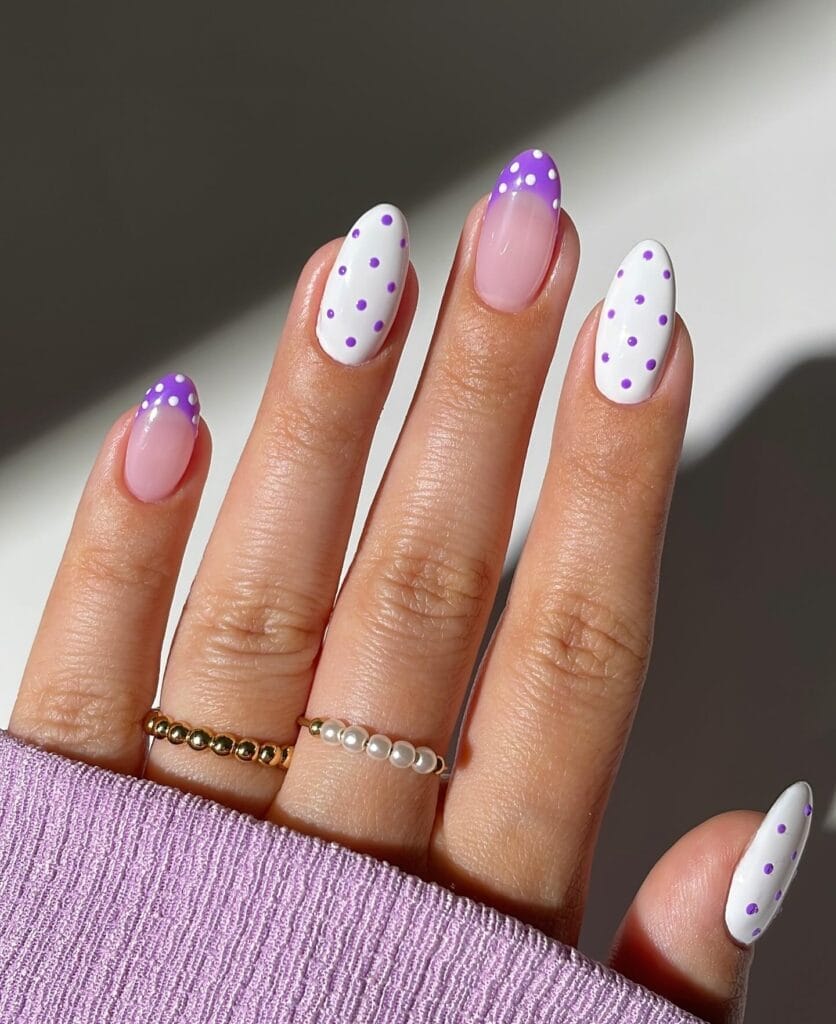 June nail ideas, purple and white polka dot French tip almond nails on sheer pink base