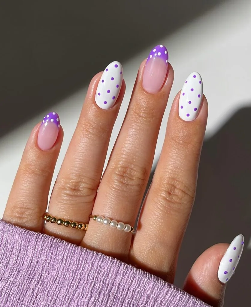 June nail ideas, purple and white polka dot French tip almond nails on sheer pink base