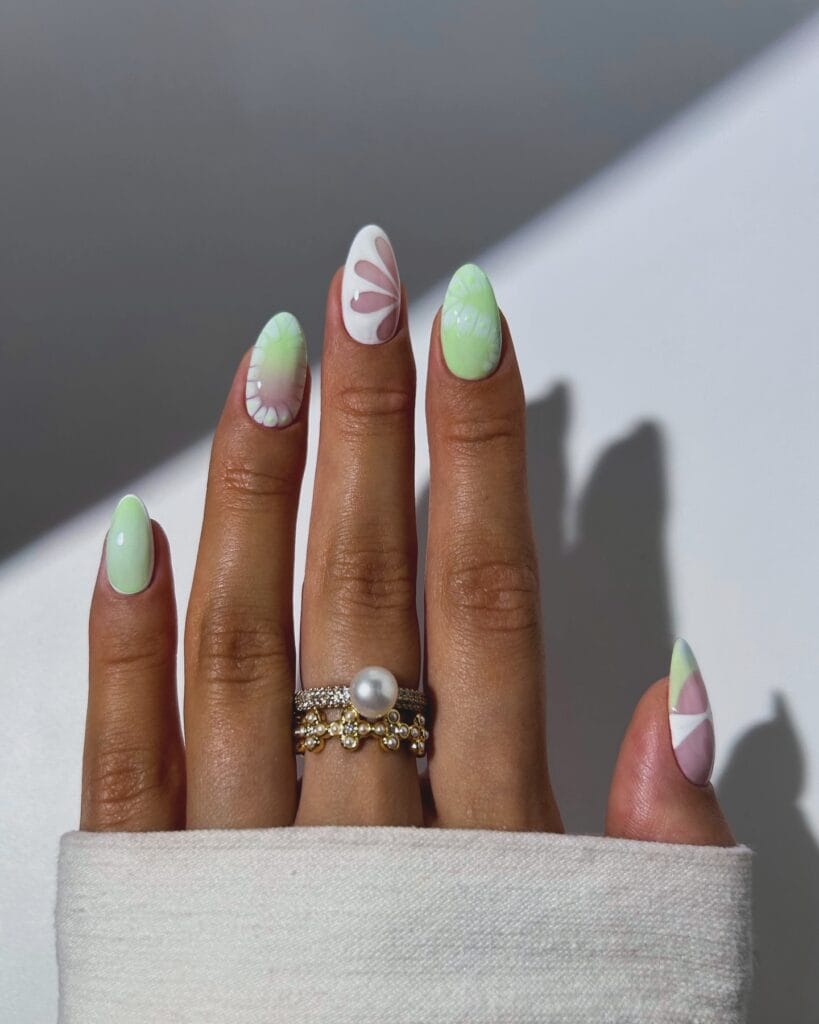 July nail ideas, pastel green and white mix and match almond nails with negative space petal and color block art
