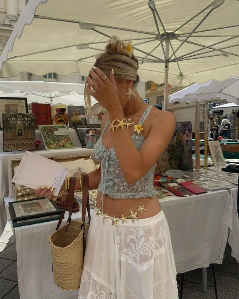 summer fashion trends 2026, gold starfish earrings and starfish waist chain with lace top and sheer skirt