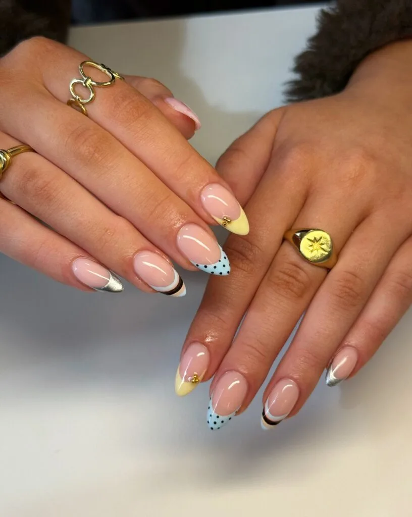 summer nail trends 2026, mismatched almond nails with polka dot yellow and silver chrome French tips