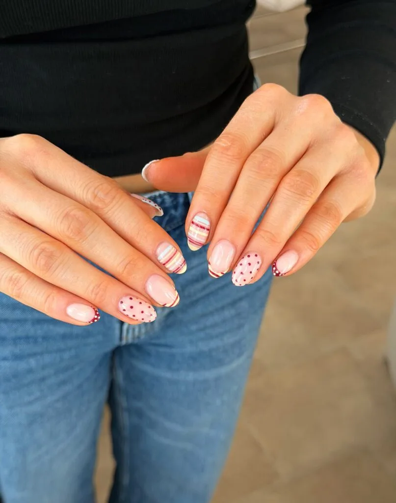 June nail ideas, mix and match almond nails with retro stripes and red polka dots on nude base
