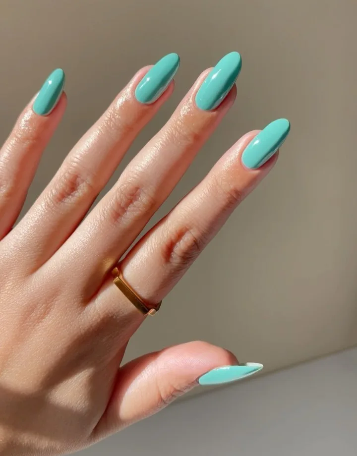 june nail color trends, turquoise ocean shimmer almond nails with pearl accents