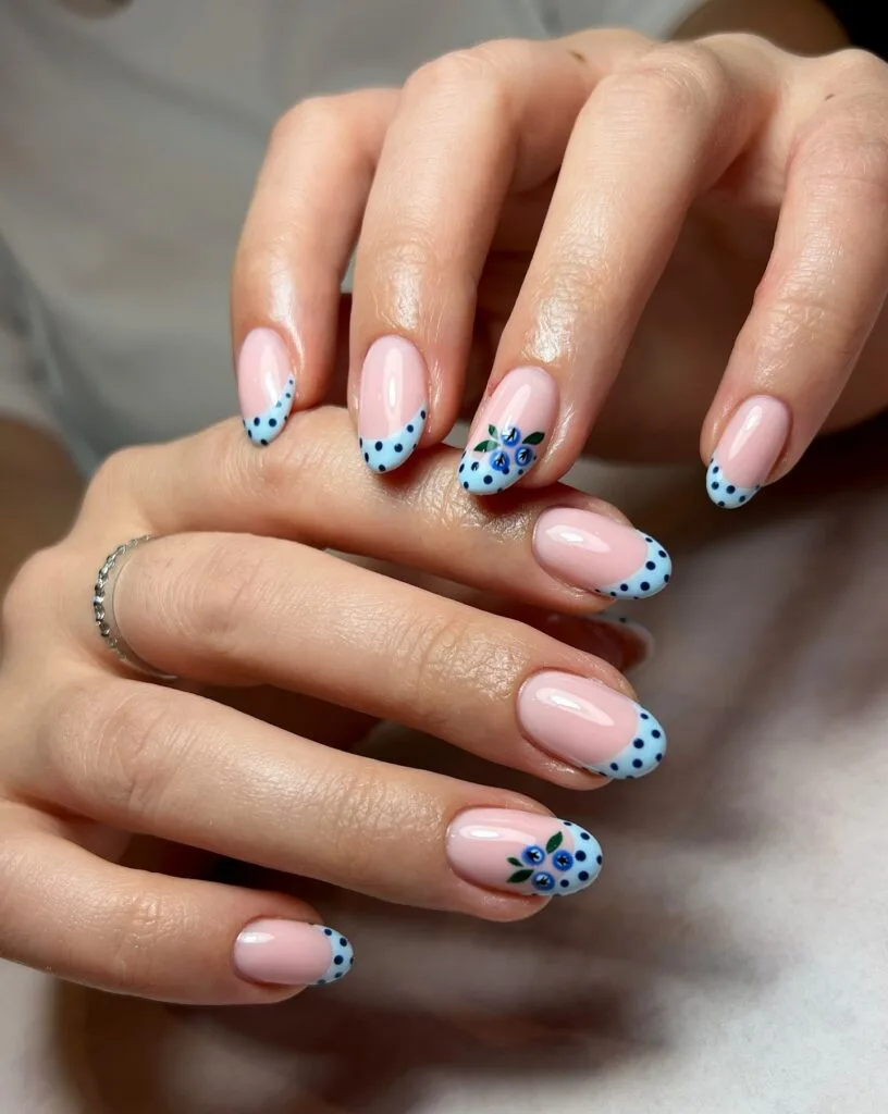 summer nail trends 2026, nude round nails with blue polka dot French tips and blueberry accents