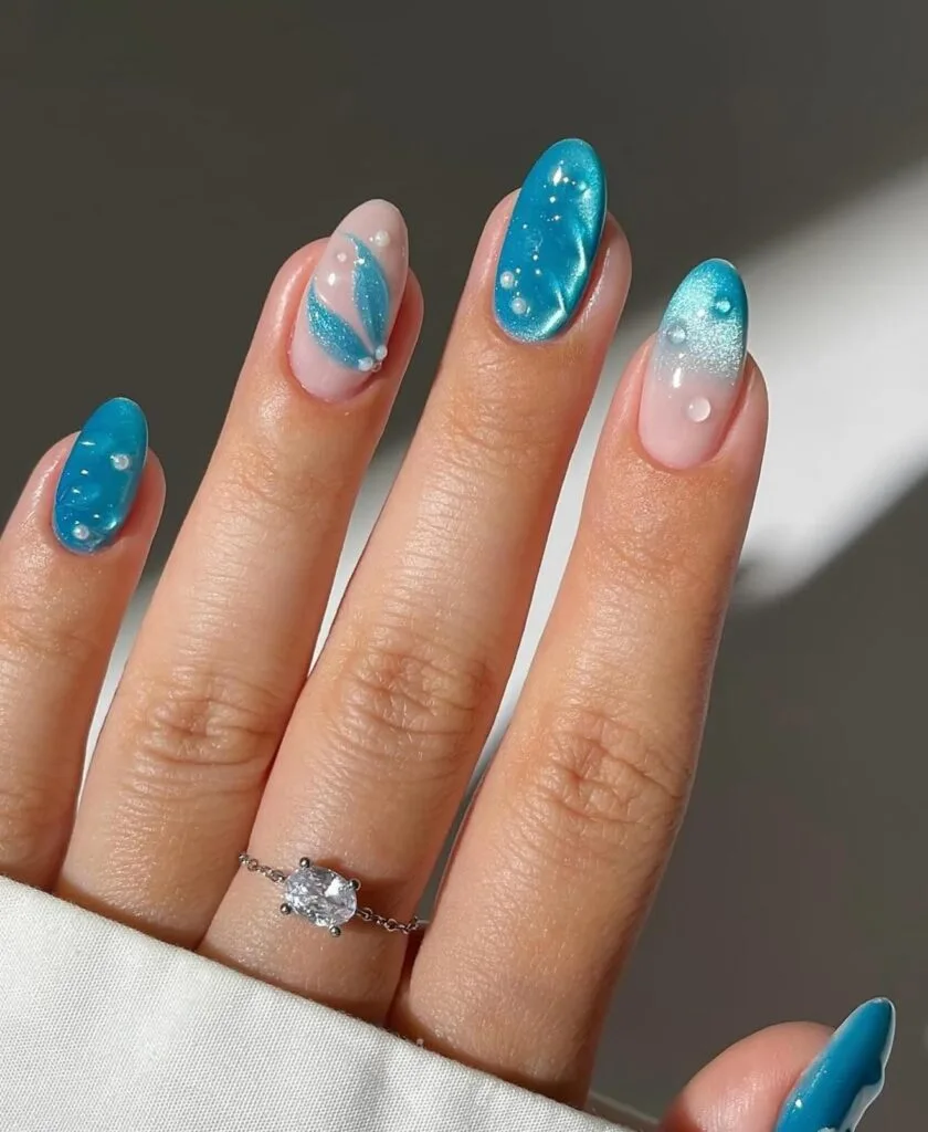 june nail color trends, solid turquoise glossy almond nails with gold ring