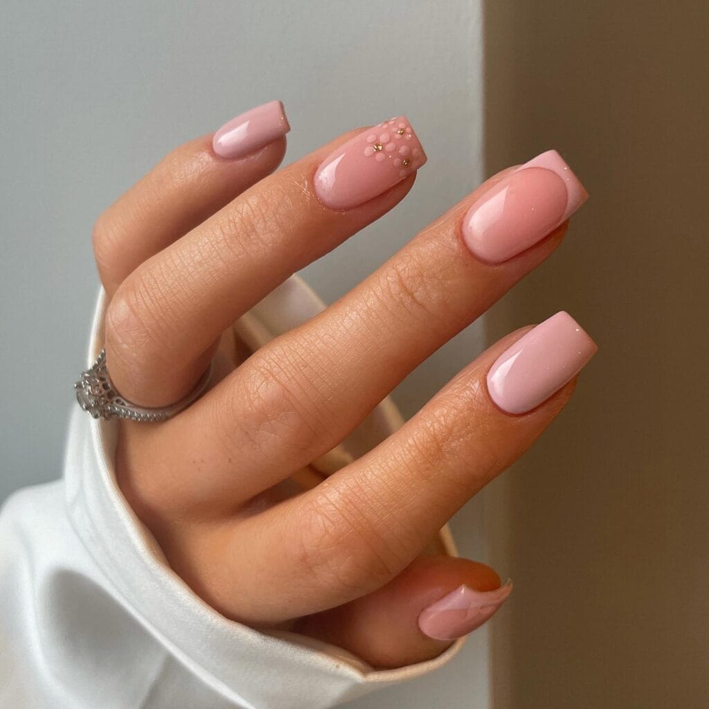 neutral summer nails, short square soft pink nails with 3D bubble dot accent nail and tiny gold studs
