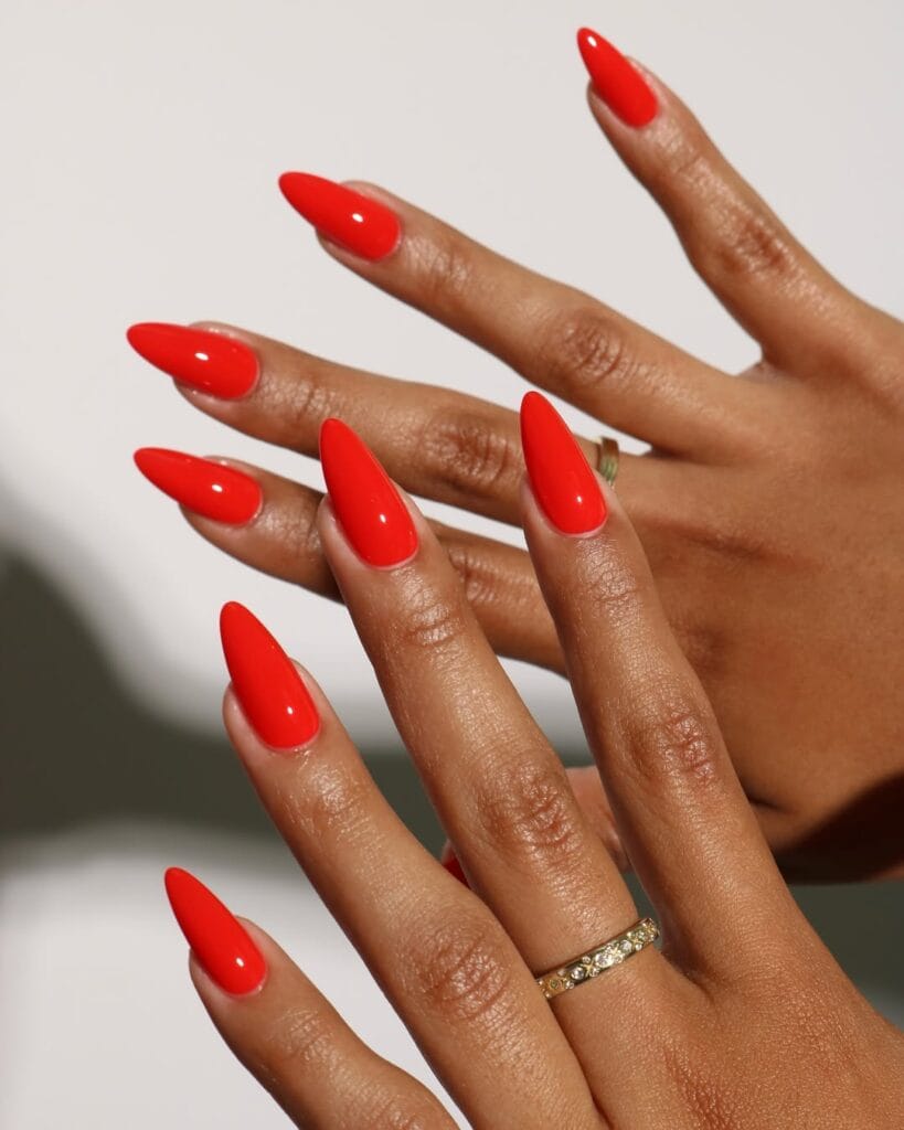 summer nail colors, tomato red glossy almond nails with gold ring