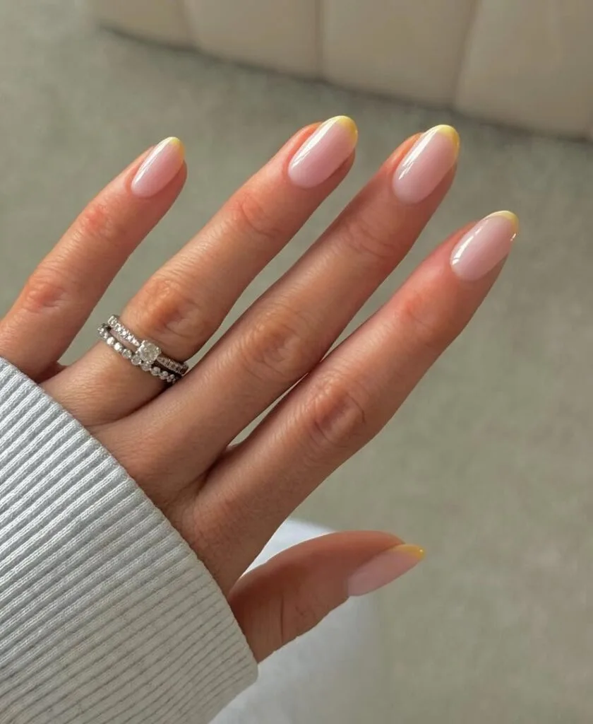 june nail color trends, thin lemon yellow French tip almond nails with sheer base