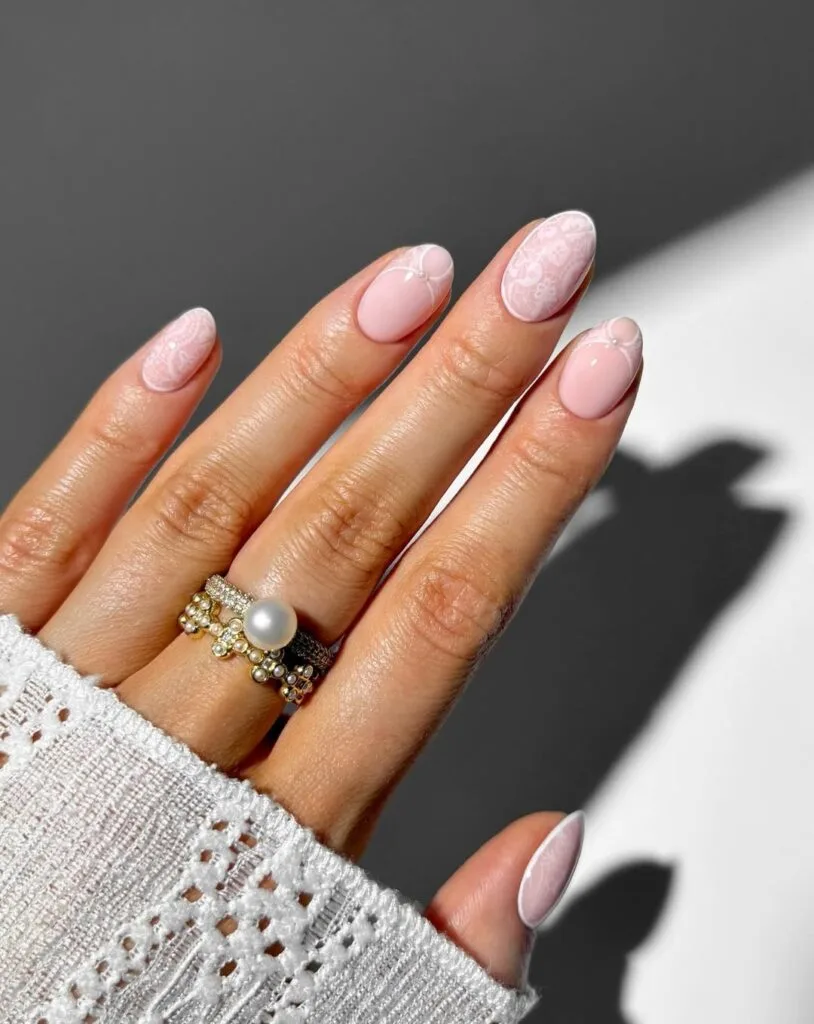 summer nail trends 2026, soft pink almond nails with subtle white lace overlay accents