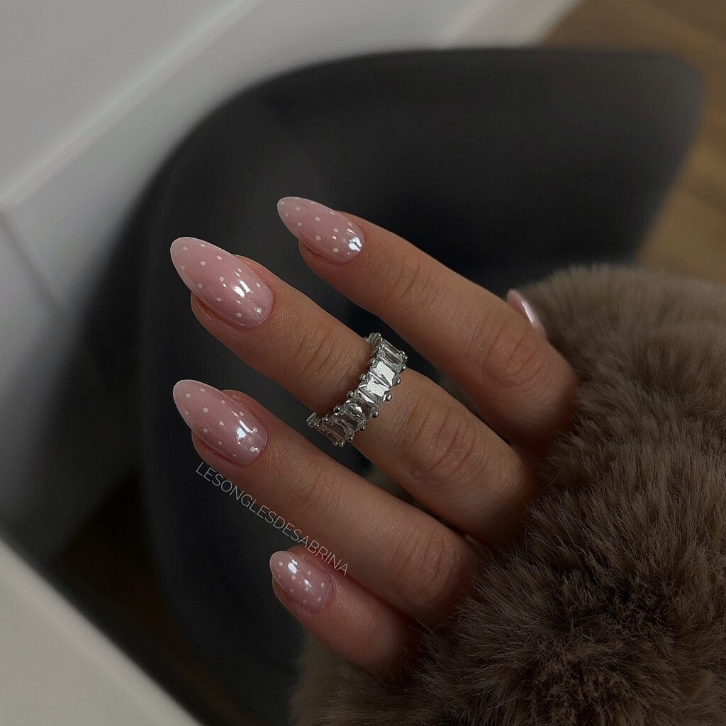 neutral summer nails, almond nude pink glazed nails with small white polka dot accents