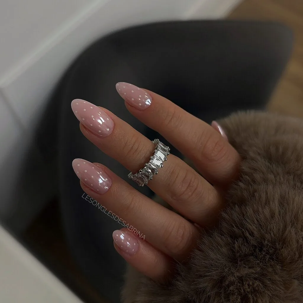 neutral summer nails, almond nude pink glazed nails with small white polka dot accents