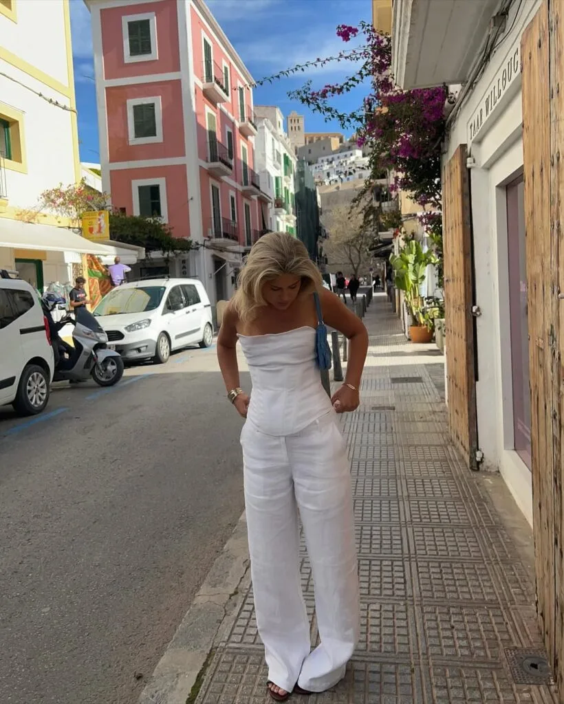 summer fashion trends 2026, white linen strapless top and matching wide-leg trousers on colorful street