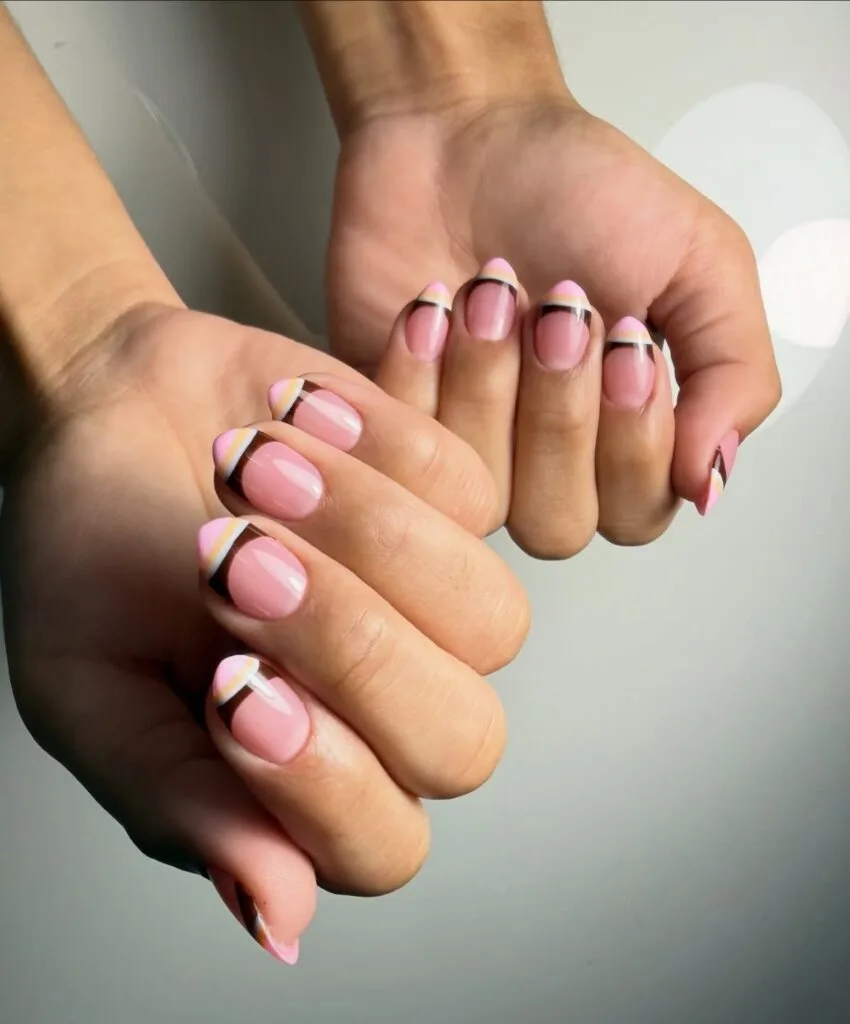summer nail trends 2026, pink nails with diagonal black yellow and white color-blocked French tips