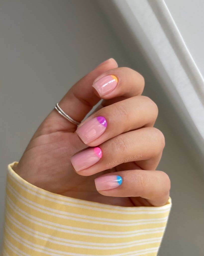June nail ideas, sheer pink short square nails with multicolor half moon accents at cuticle

