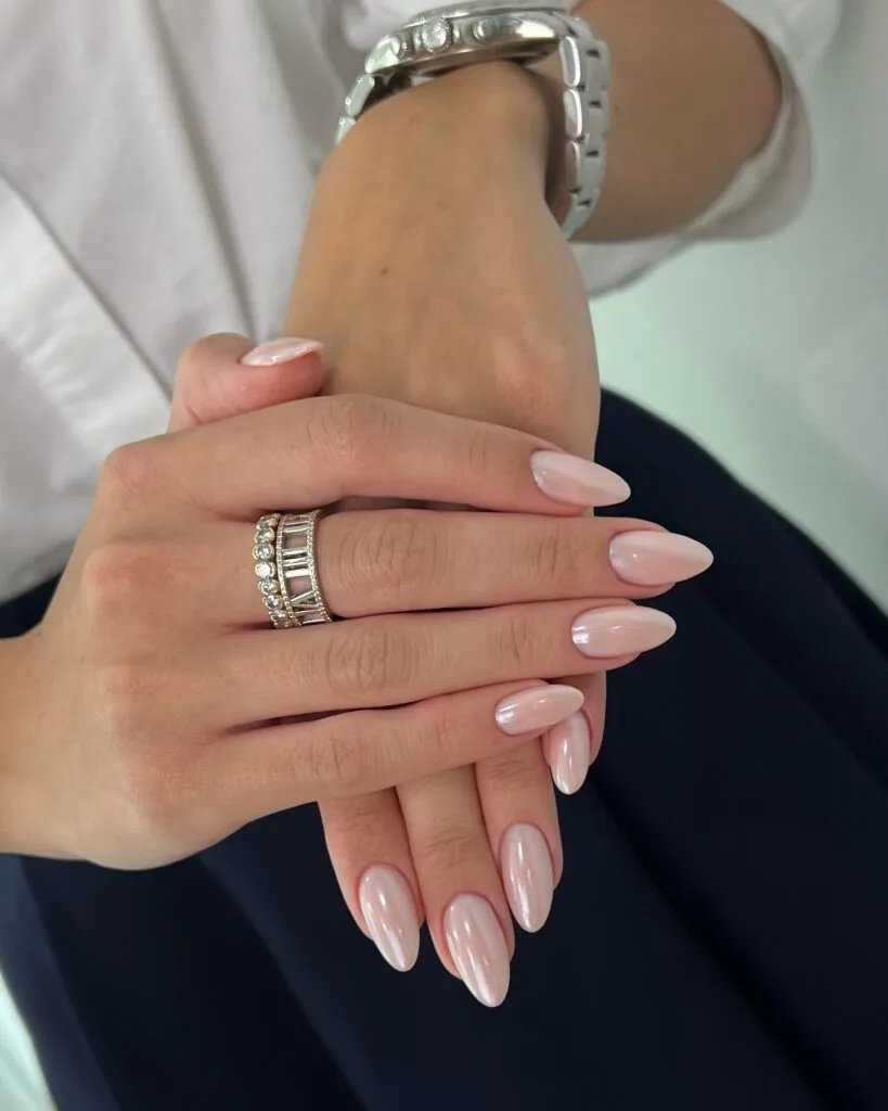 summer nail trends 2026, sheer pink pearlescent almond nails with soft shimmer finish