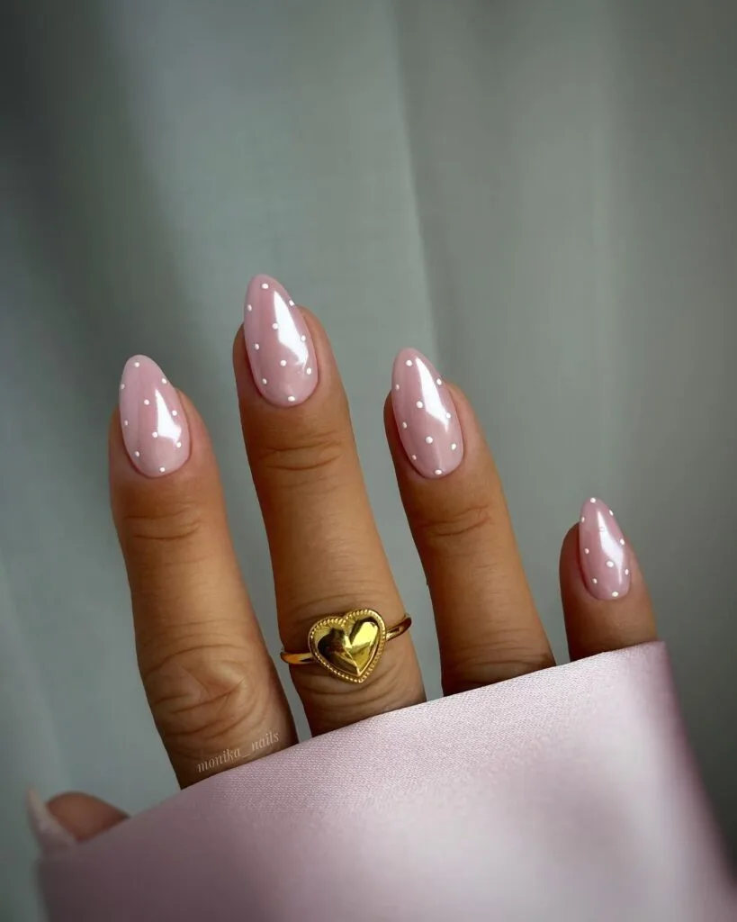 summer nail trends 2026, soft pink almond nails with white micro dots and subtle shimmer