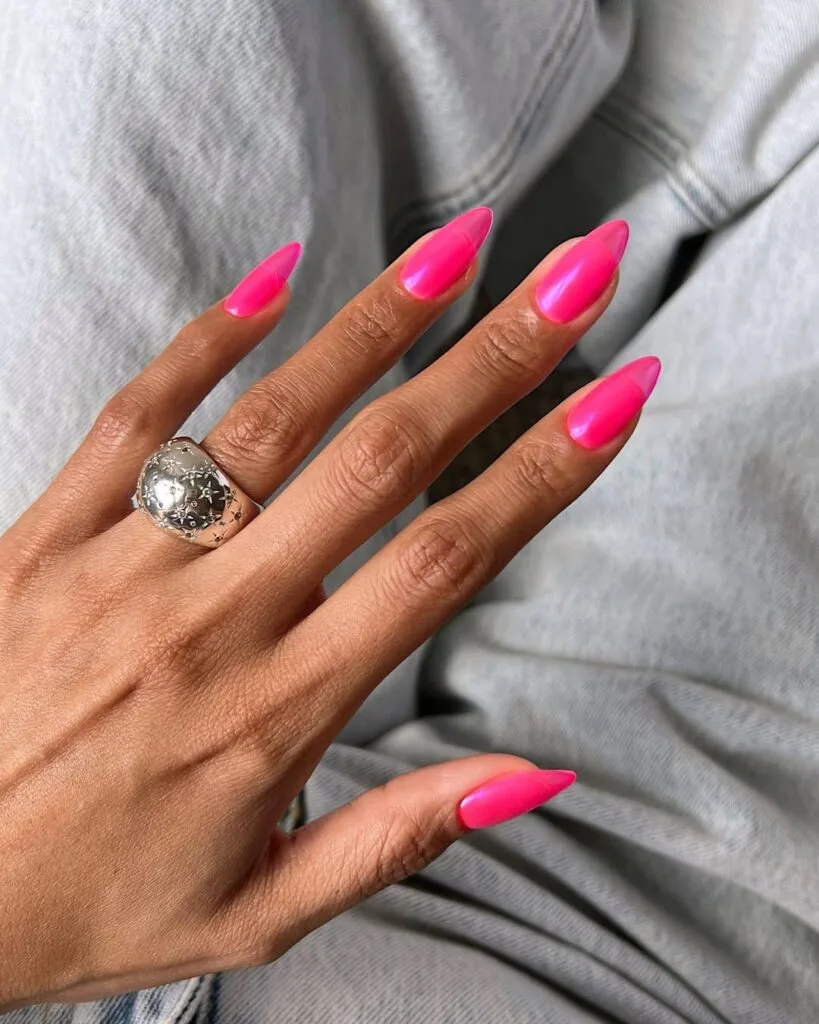june nail color trends, neon hot pink glossy almond nails with silver ring