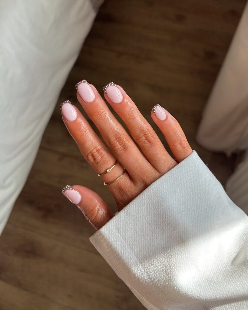 July nail ideas, milky pink short square nails with tiny black polka dot French tip edges