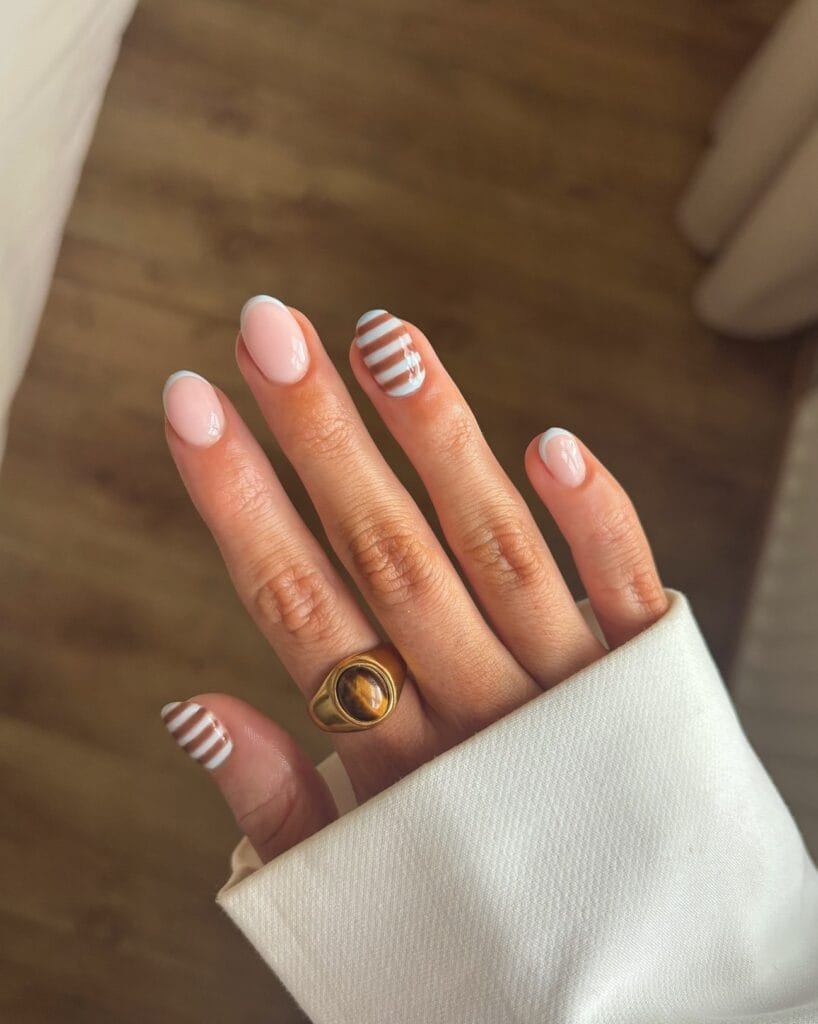 summer nail trends 2026, nude short nails with white French tips and baby blue striped accent