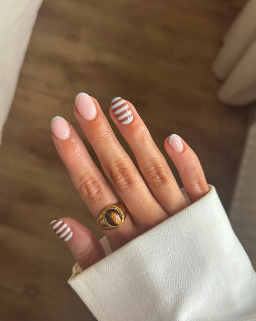 summer nail trends 2026, nude short nails with white French tips and baby blue striped accent
