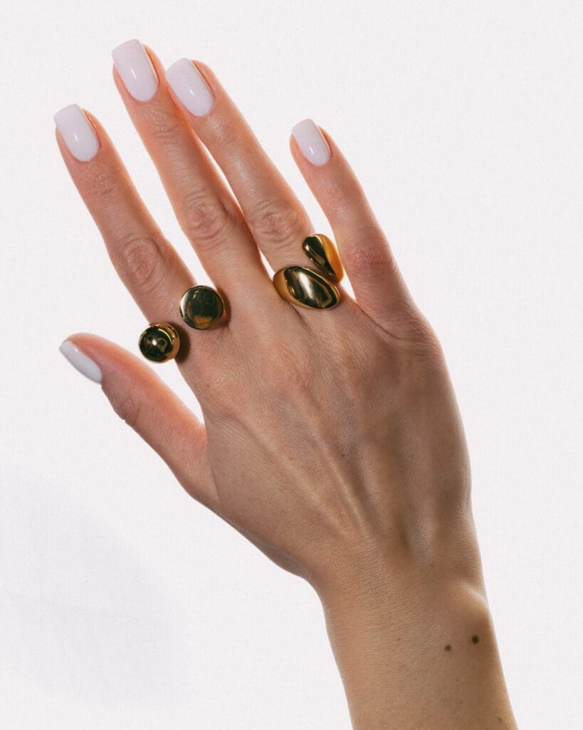  June nail ideas, milky white glossy long square nails with gold sculptural rings
