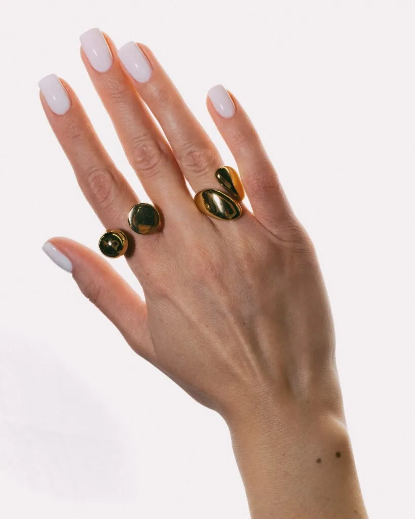  June nail ideas, milky white glossy long square nails with gold sculptural rings
