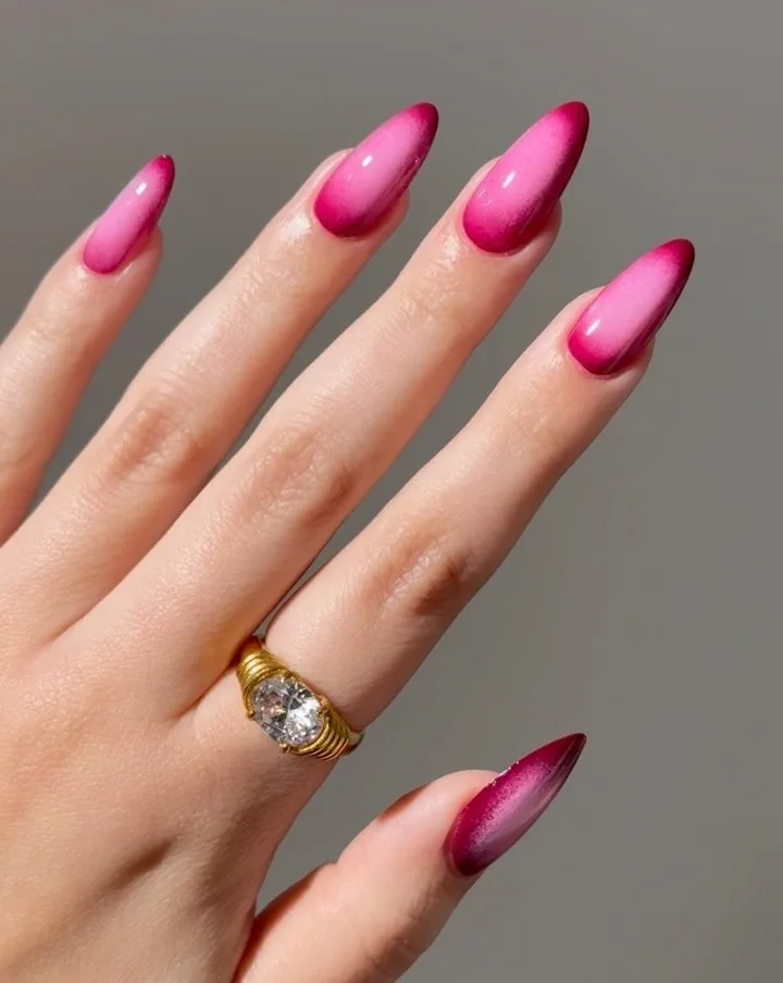 july nail colors, pink aura almond nails with dark magenta edges fading to a light center