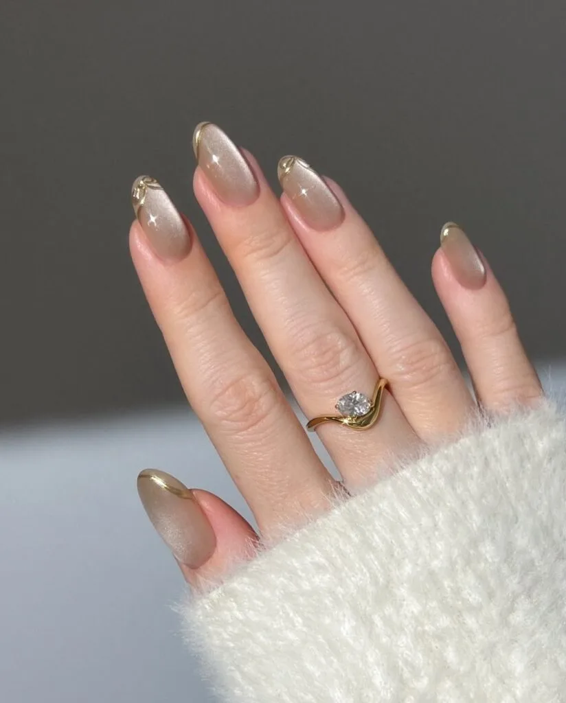 july nail colors, nude almond nails with gold glitter French tips