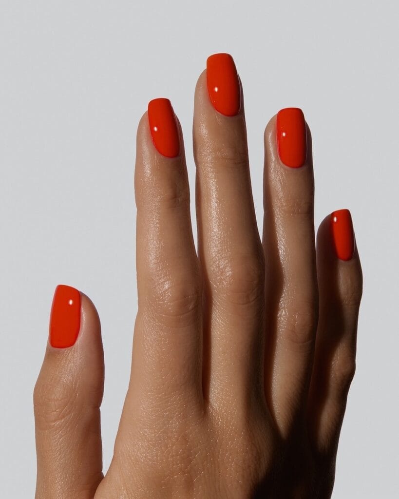 july nail colors, vivid orange red square nails with glossy solid finish