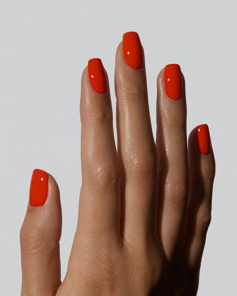july nail colors, vivid orange red square nails with glossy solid finish