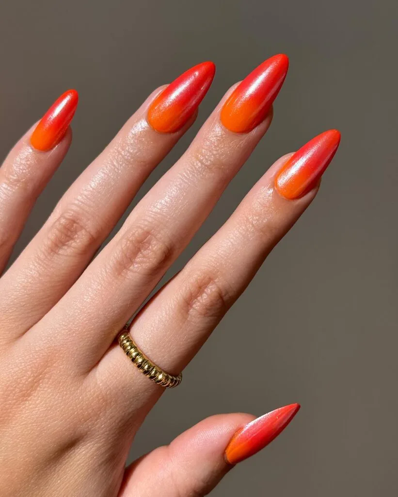 july nail colors, red to orange ombre almond nails with shimmery sunset fade
