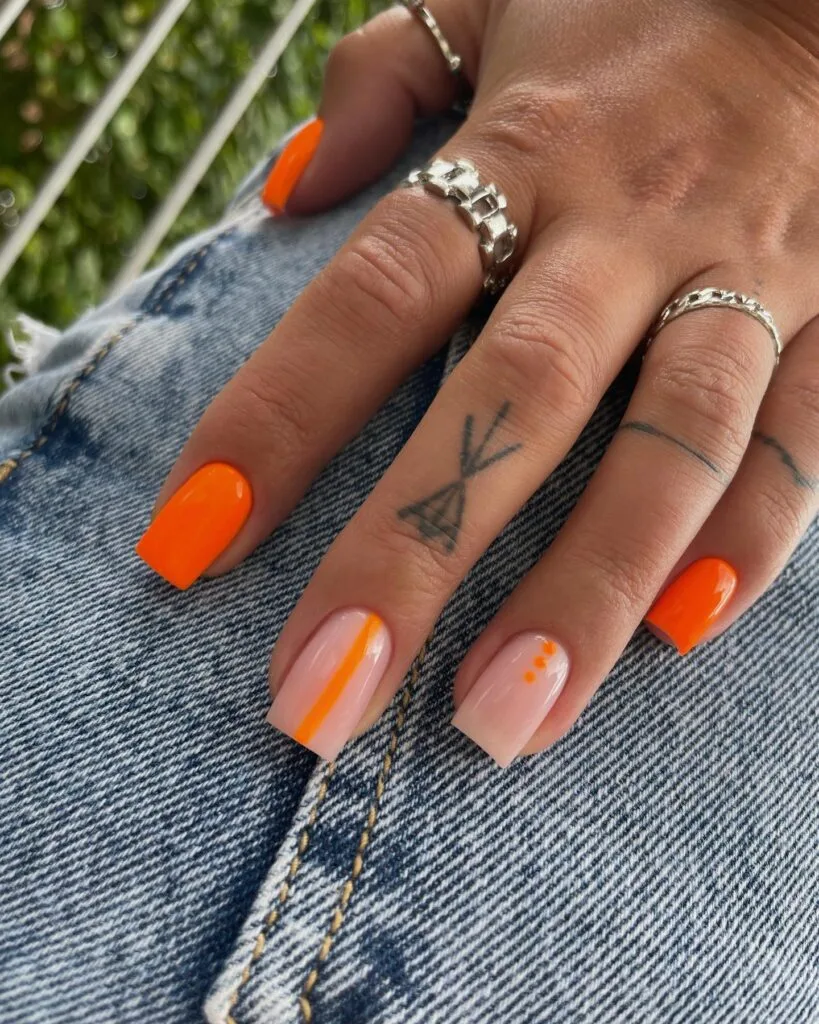 july nail colors, bright neon orange square nails with milky accent nails and thin stripe and dot art