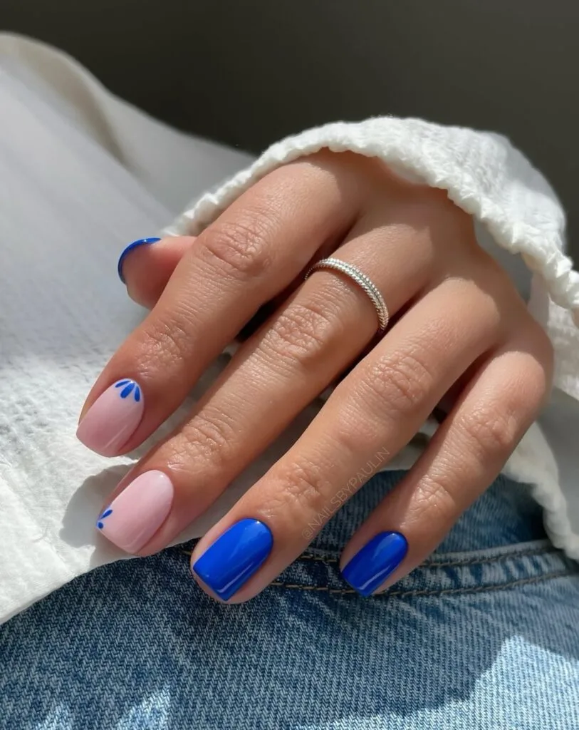 august nail colors 2026, short square cobalt blue and sheer pink nails with blue petal accents