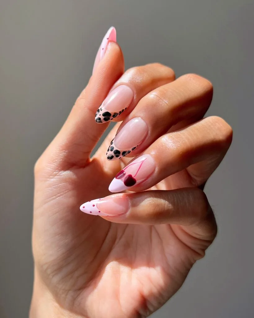 august nails, long almond mix and match French with leopard print tips, cherry art, and red polka dots on sheer base
