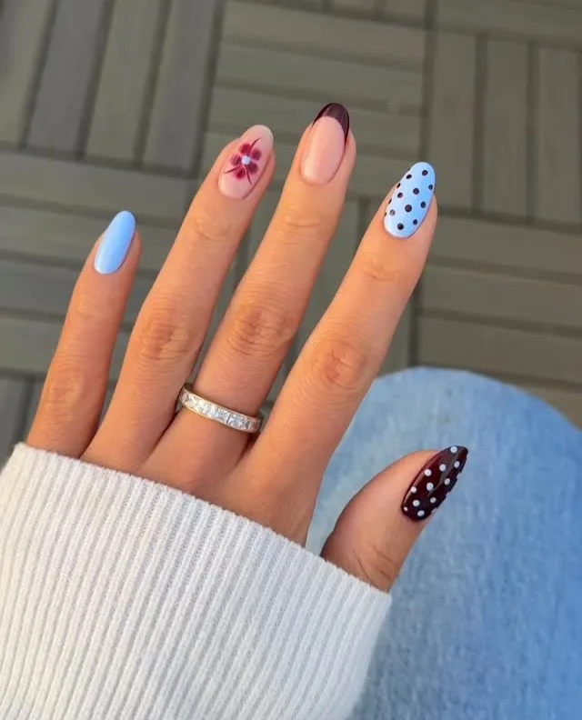 august nails, oval mix with periwinkle blue, black cherry French tip, polka dots, and burgundy flower
