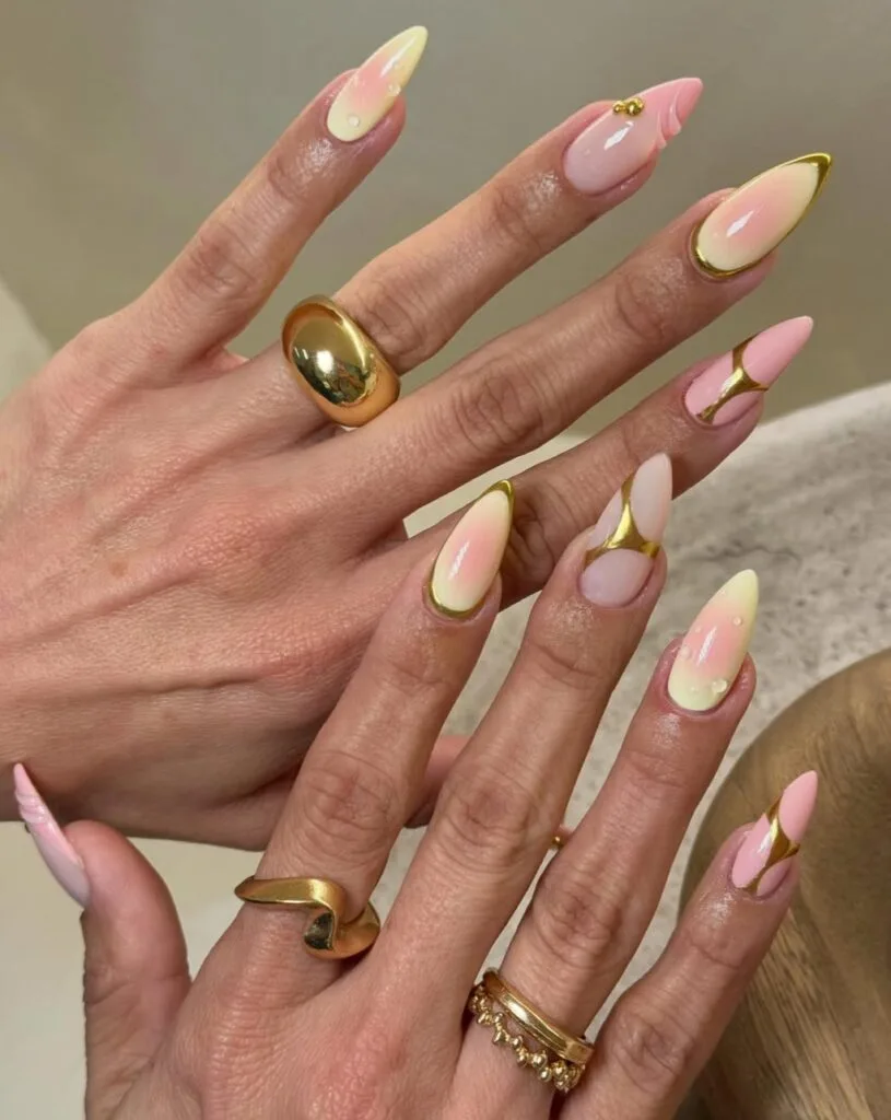 august nails, long stiletto peach and lemon aura nails with gold chrome borders and 3D water drops
