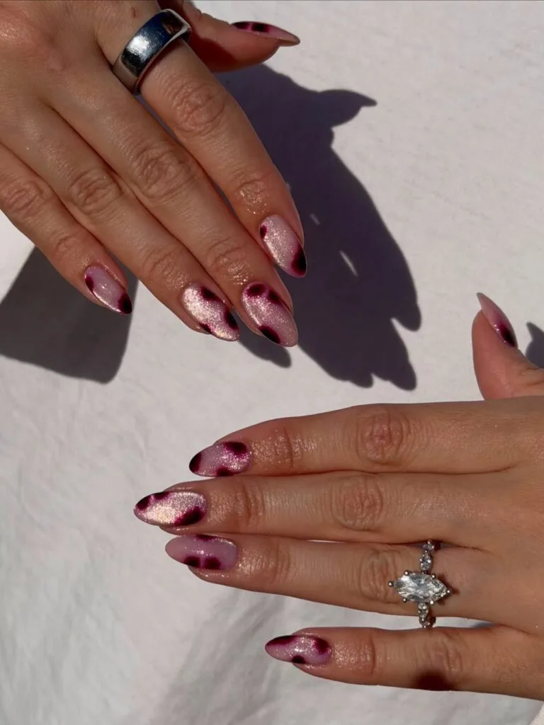 summer nails, almond champagne glitter cat eye nails with blurred plum animal print spots
