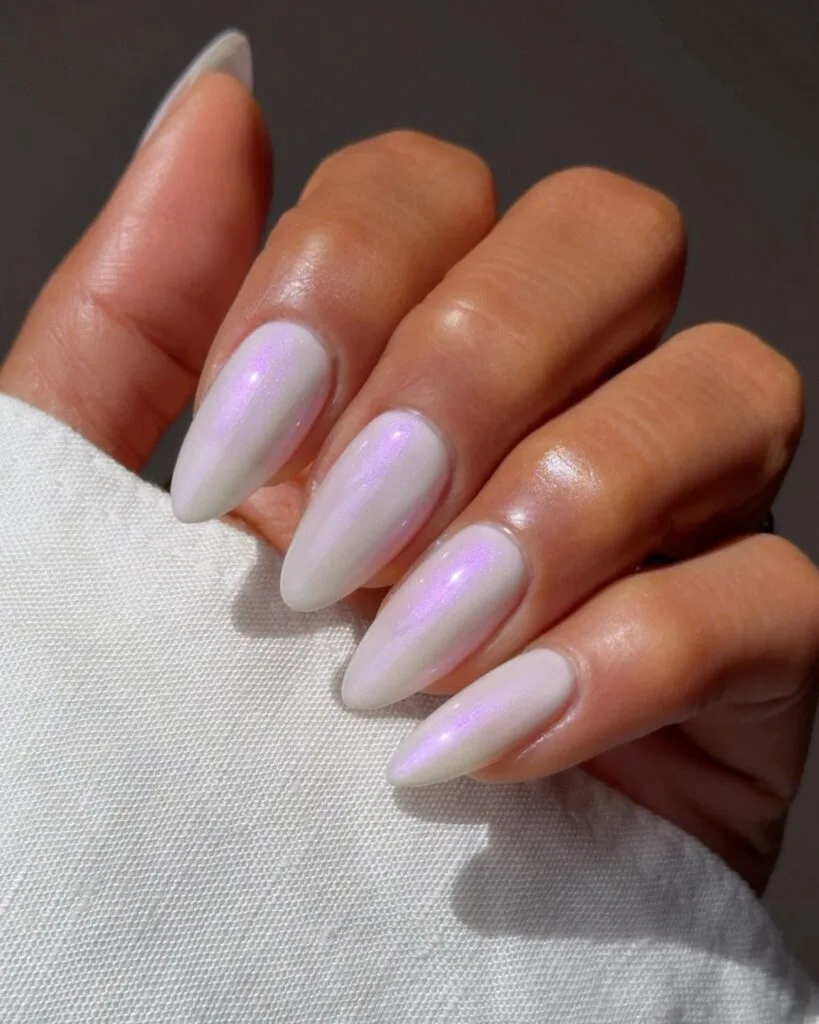 august nail colors 2026, long almond pearl white nails with pink iridescent shimmer