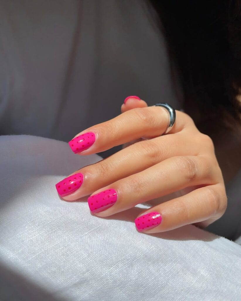 august nails, short square hot pink nails with tiny red polka dots