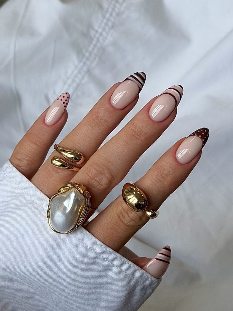 summer nails, almond nude nails with chocolate brown striped, dotted, and freckled French tips