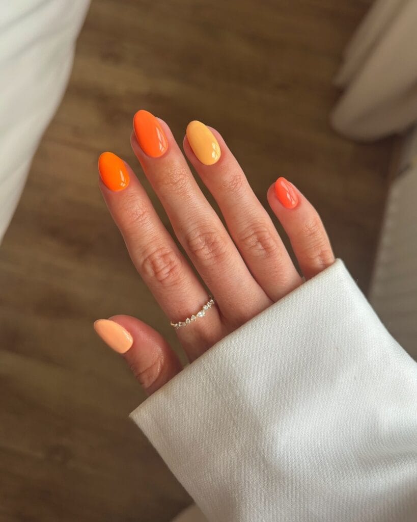 august nail colors 2026, round nails in mixed orange shades from tangerine to peach