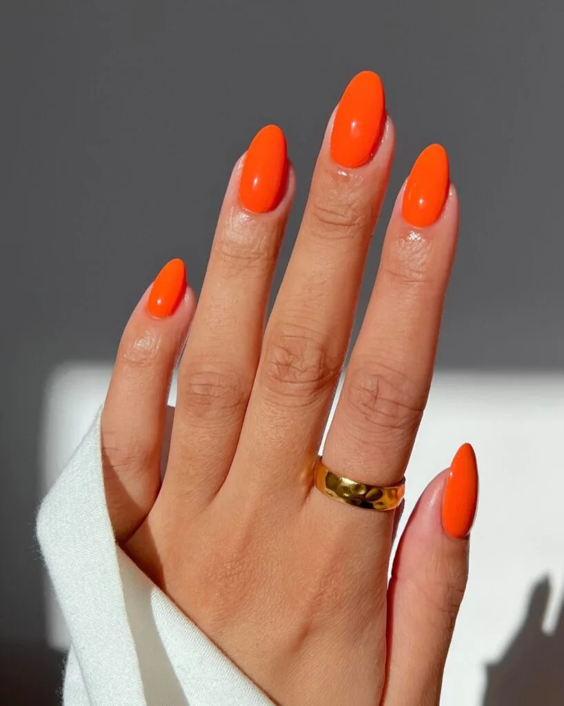 trending nail colors, vivid red orange almond nails with glossy finish