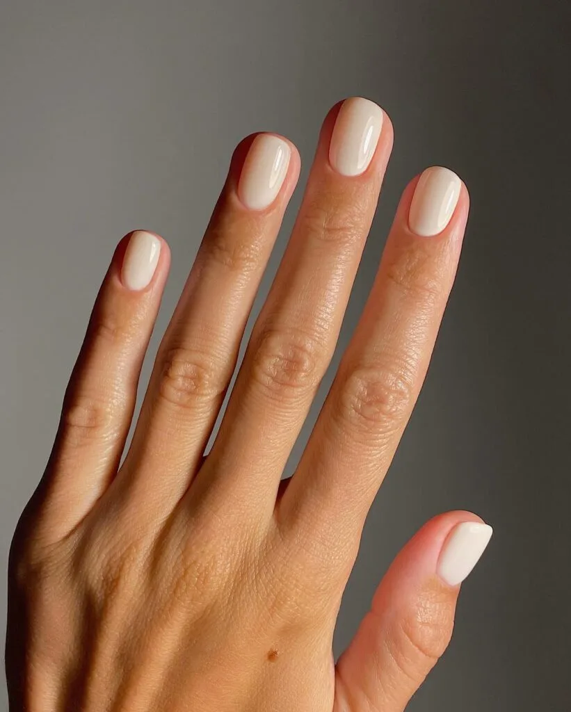 august nail colors 2026, short round creamy vanilla nude nails