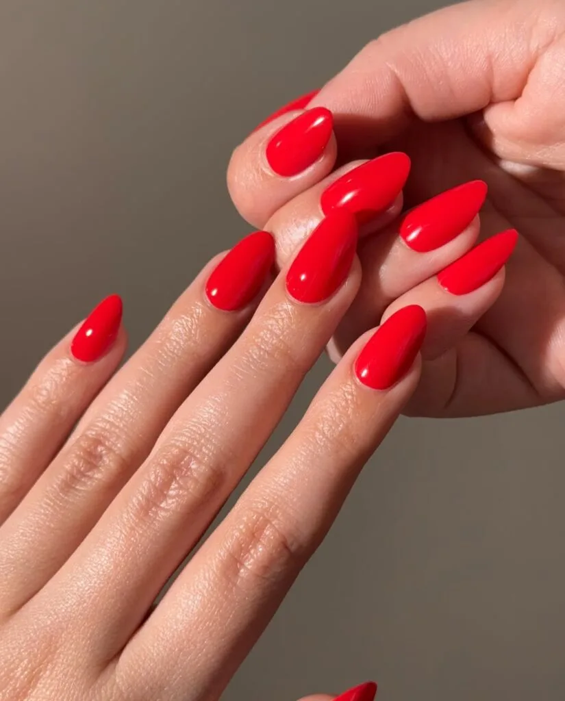 august nail colors 2026, glossy bright poppy red almond nails